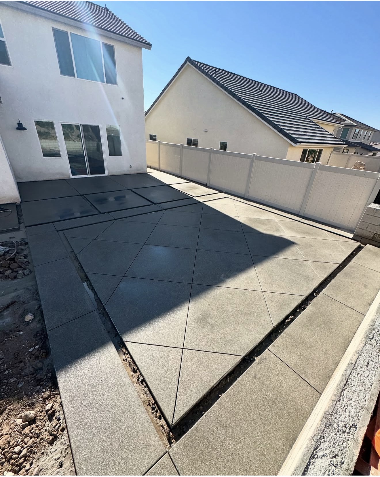 Diamond-Pattern Concrete Pad & Turf Strips — before state
