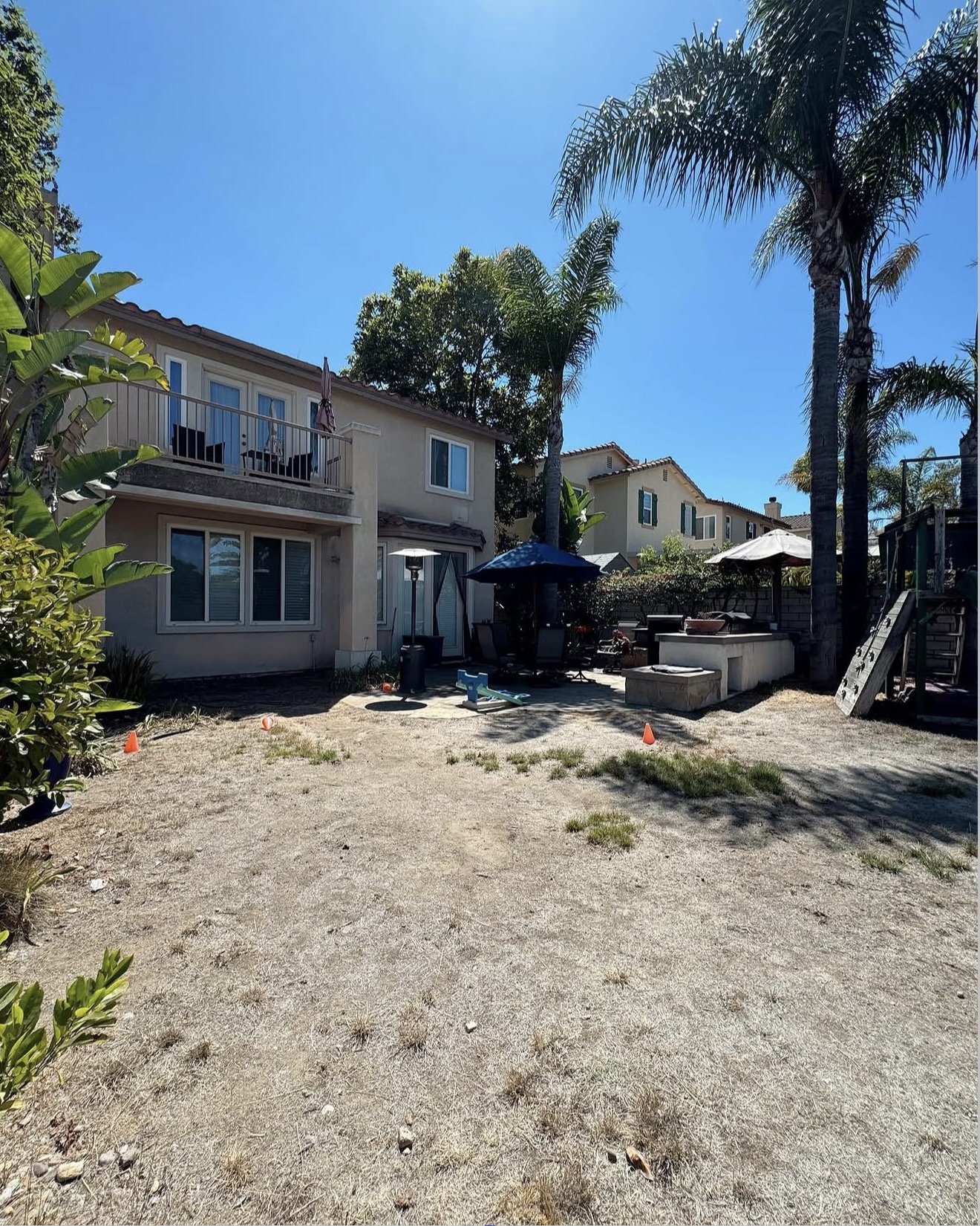 Two-Story Home Backyard Patio & Turf — before state