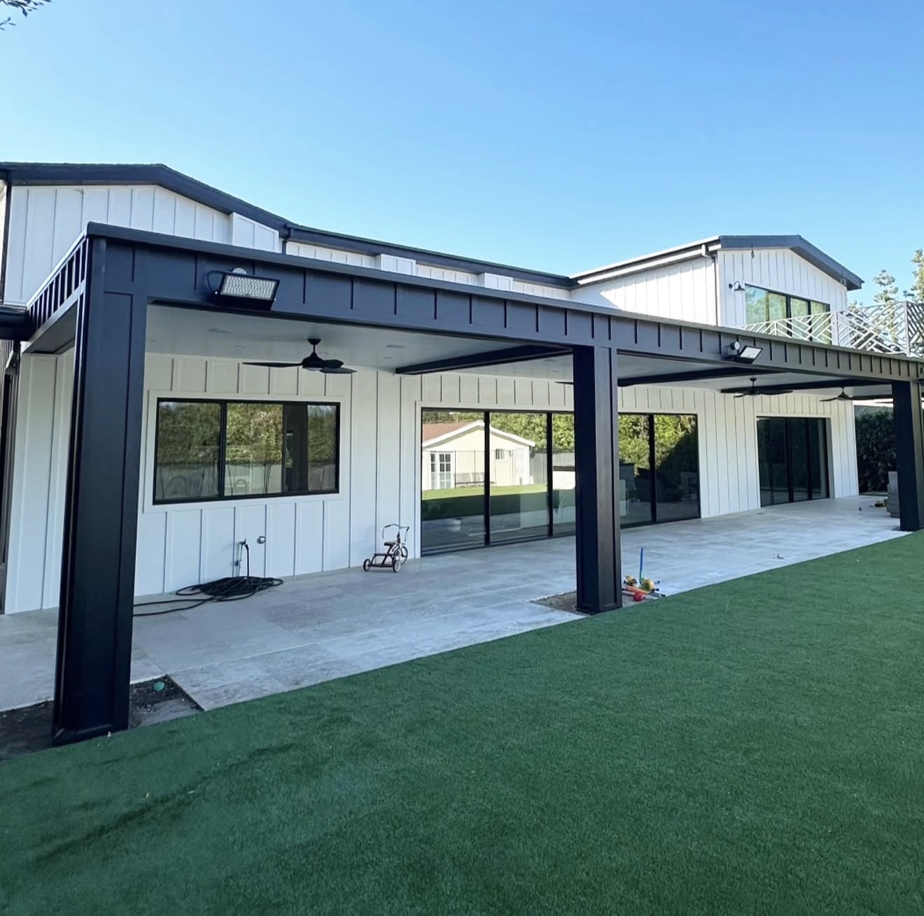 Black Steel Pergola Over Concrete Patio — completed project