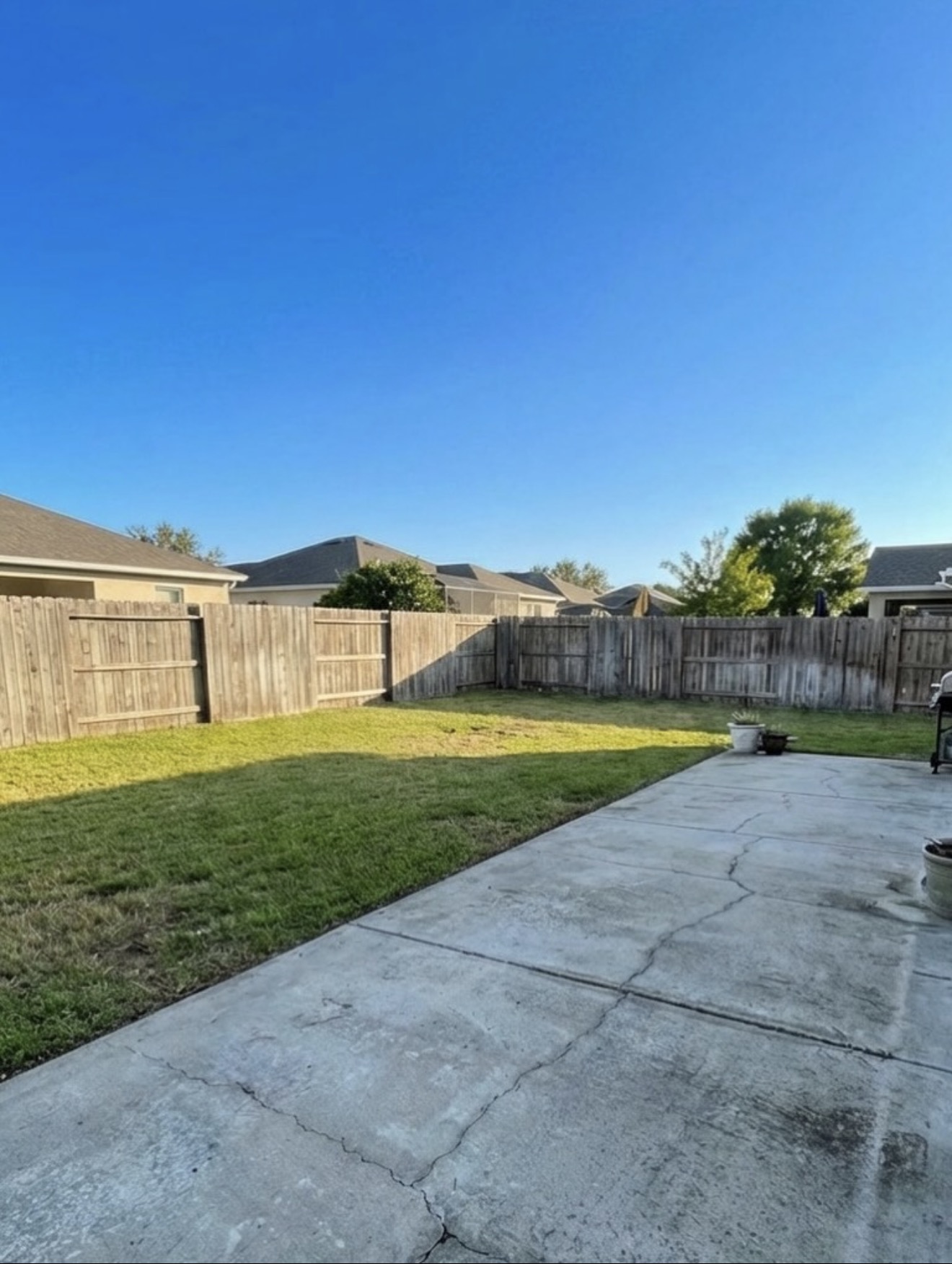 Gray Paver Patio with Sectional & Firepit — before state