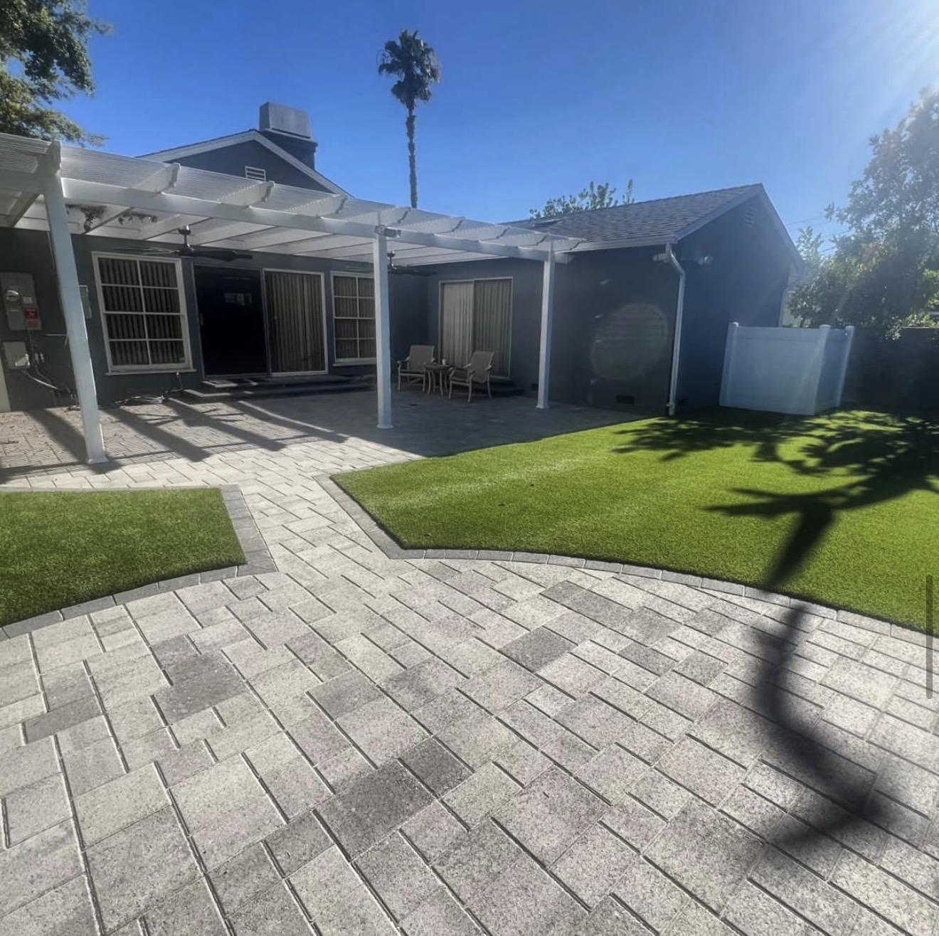 White Pergola Over Stamped Paver Patio — completed project