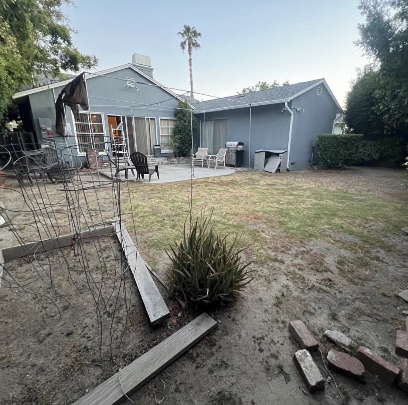 White Pergola Over Stamped Paver Patio — before state